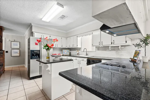 a living room with a fireplace a flat screen tv and a rug