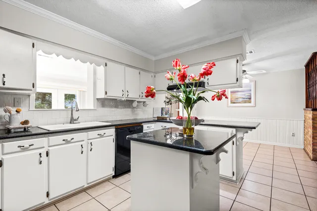 a view of an empty room with window and fire place