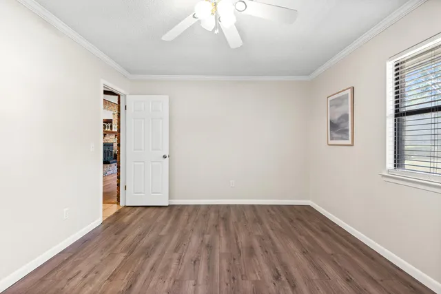 a view of a brick house with potted plants in front of door