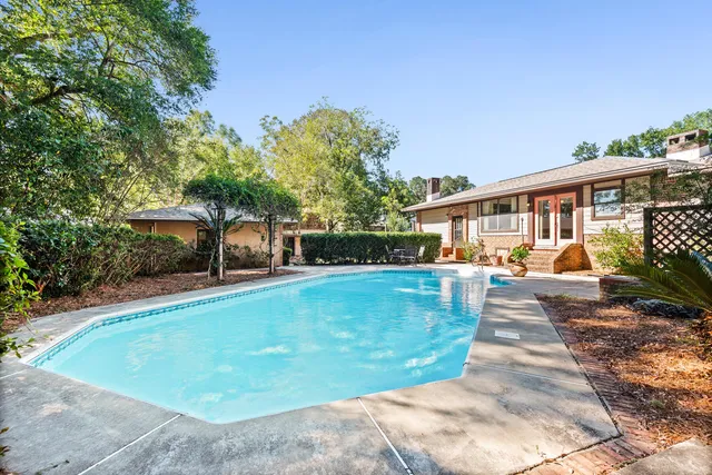 a bathroom with a granite countertop sink mirror and shower
