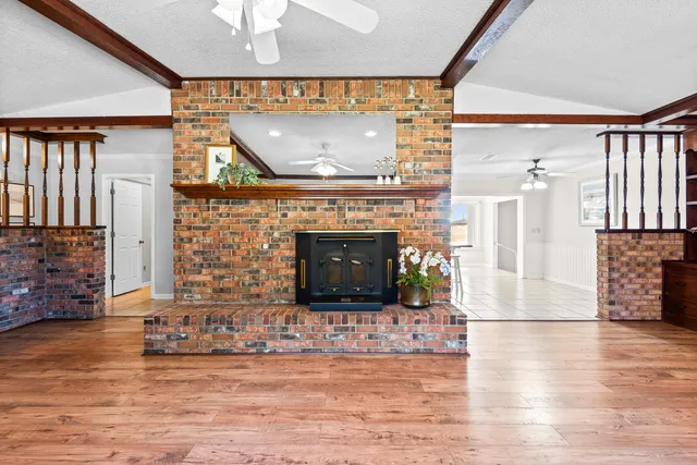 a view of a livingroom with furniture and a fireplace