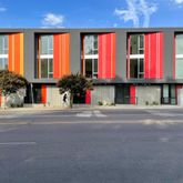 a view of multi story building with large trees