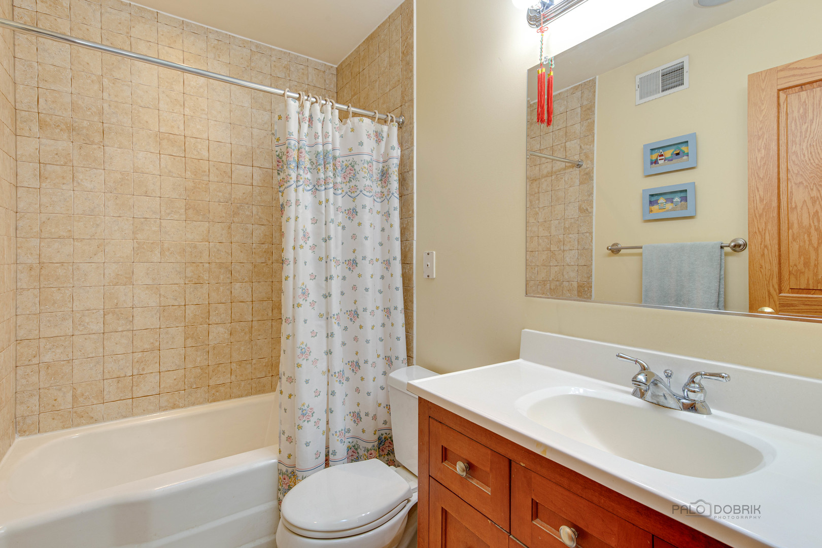 1865 Everett Avenue Des Plaines, IL 60018 - Photo 18 of 38 a bathroom with a granite countertop sink a toilet a mirror a bathtub and shower
