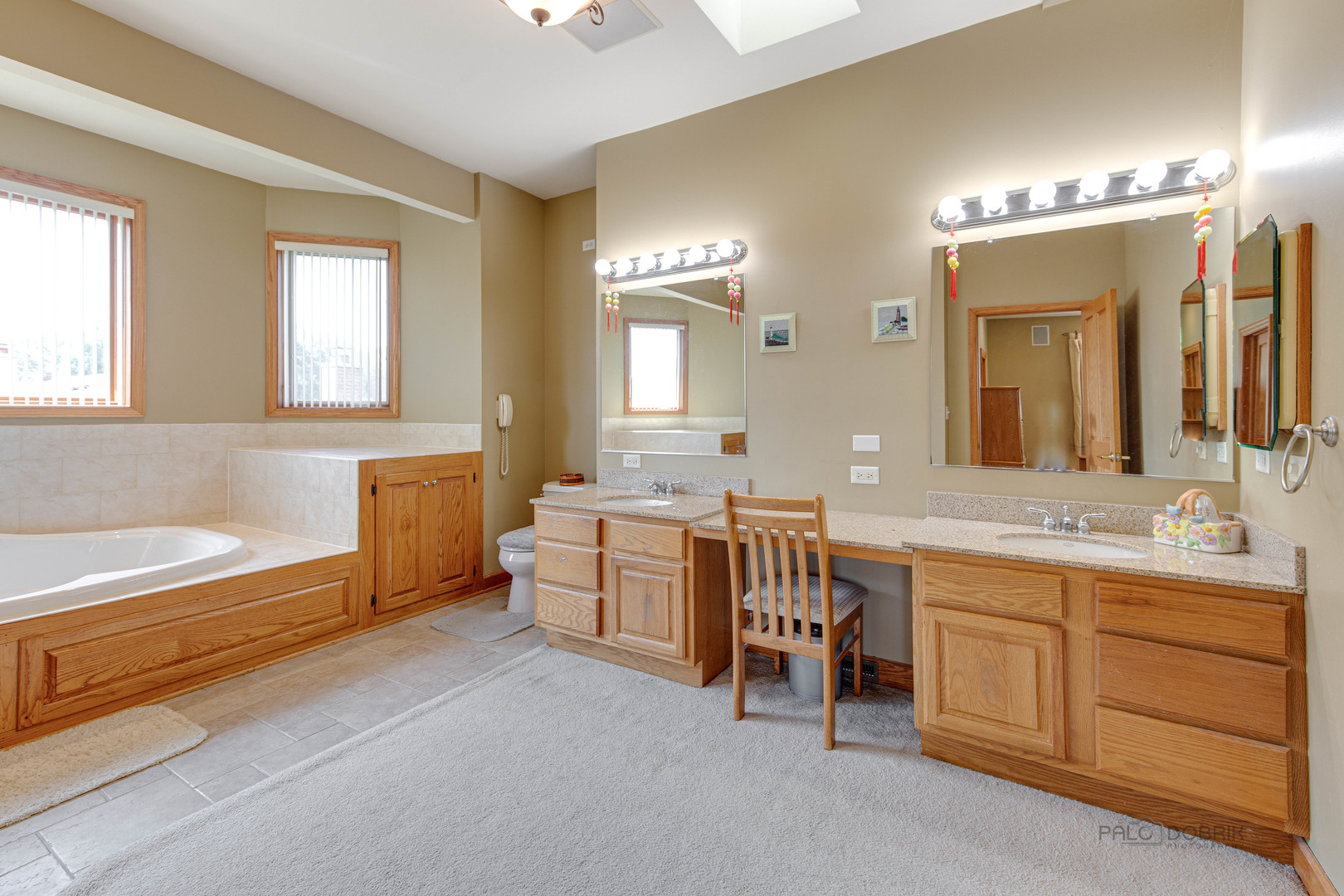 1865 Everett Avenue Des Plaines, IL 60018 - Photo 25 of 38 a spacious bathroom with a double vanity sink large mirror and a bathtub