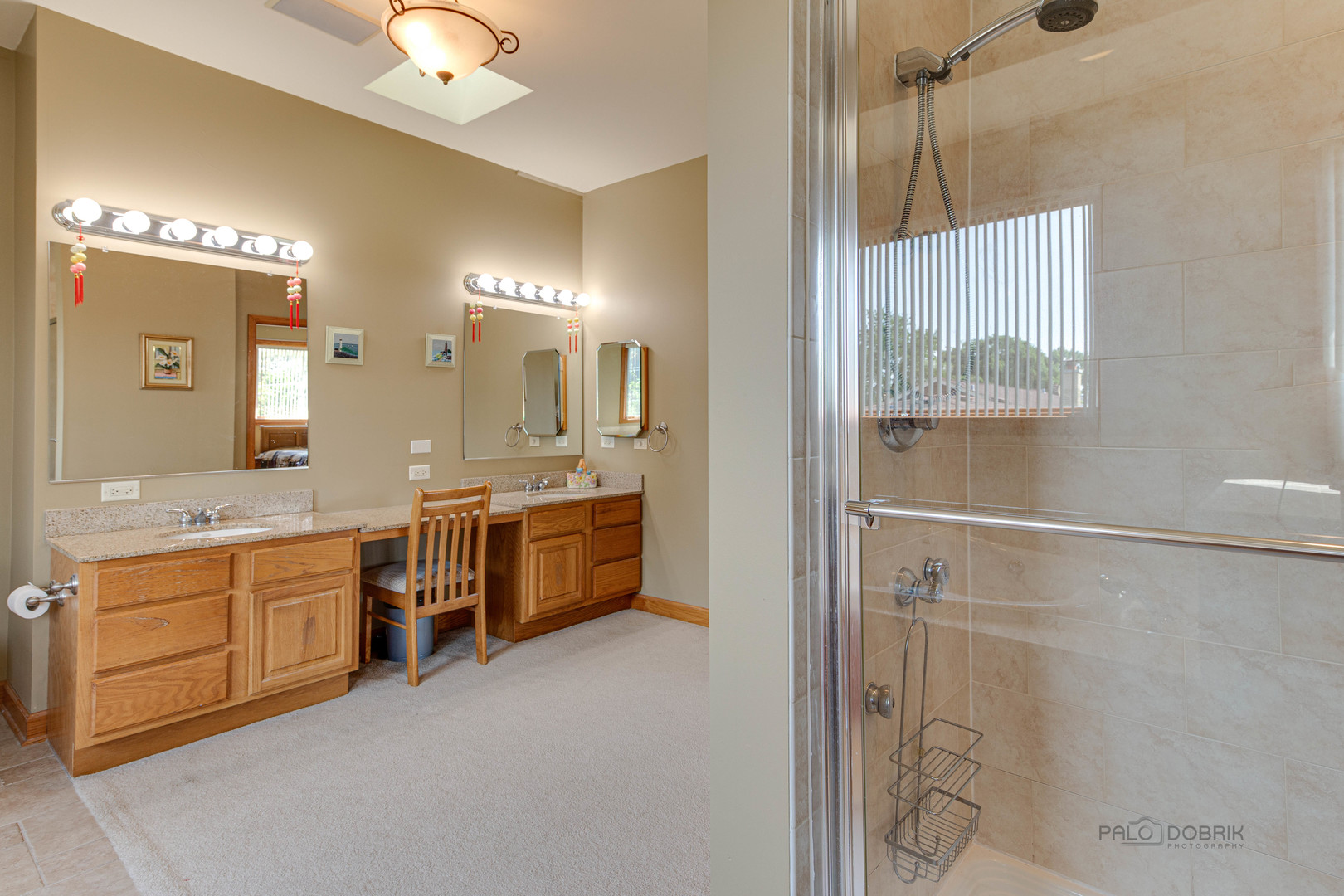1865 Everett Avenue Des Plaines, IL 60018 - Photo 26 of 38 a bathroom with a double vanity sink a mirror a bathtub and shower
