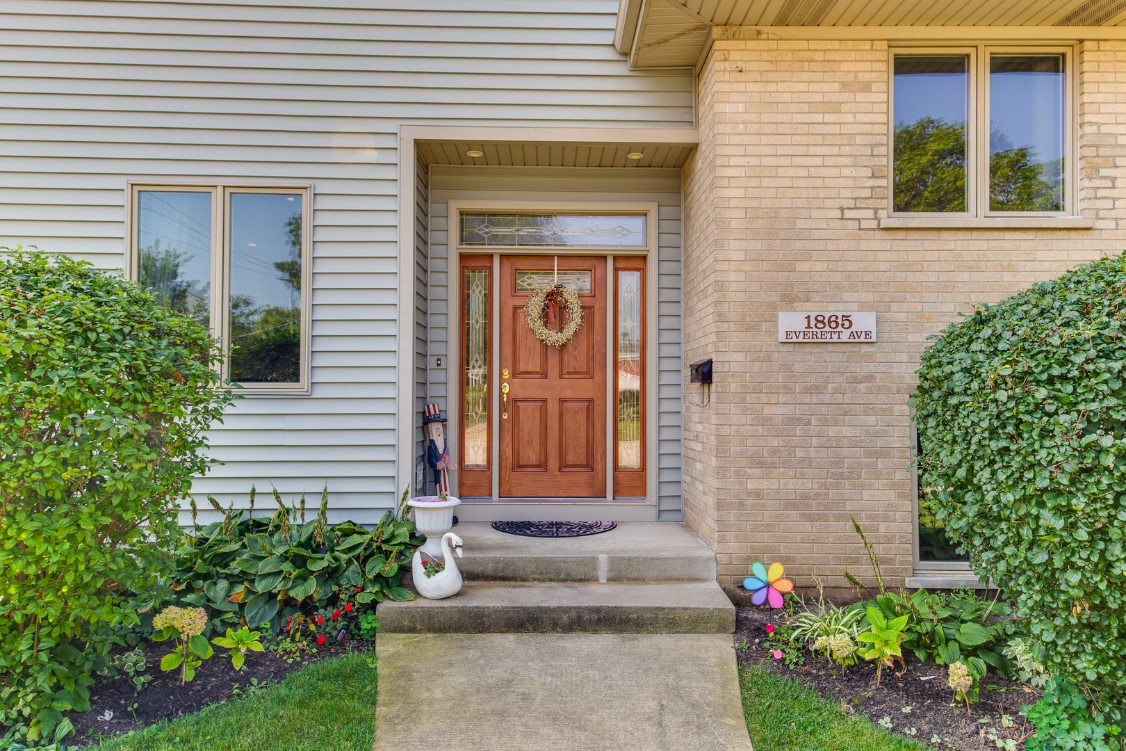 1865 Everett Avenue Des Plaines, IL 60018 - Photo 3 of 38 a front view of a house with a garden