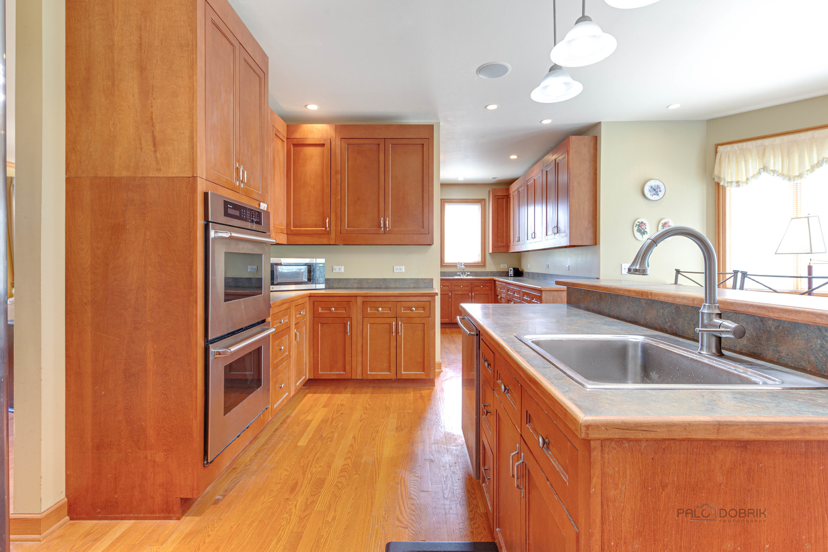 1865 Everett Avenue Des Plaines, IL 60018 - Photo 10 of 38 a kitchen with stainless steel appliances granite countertop a sink stove and refrigerator