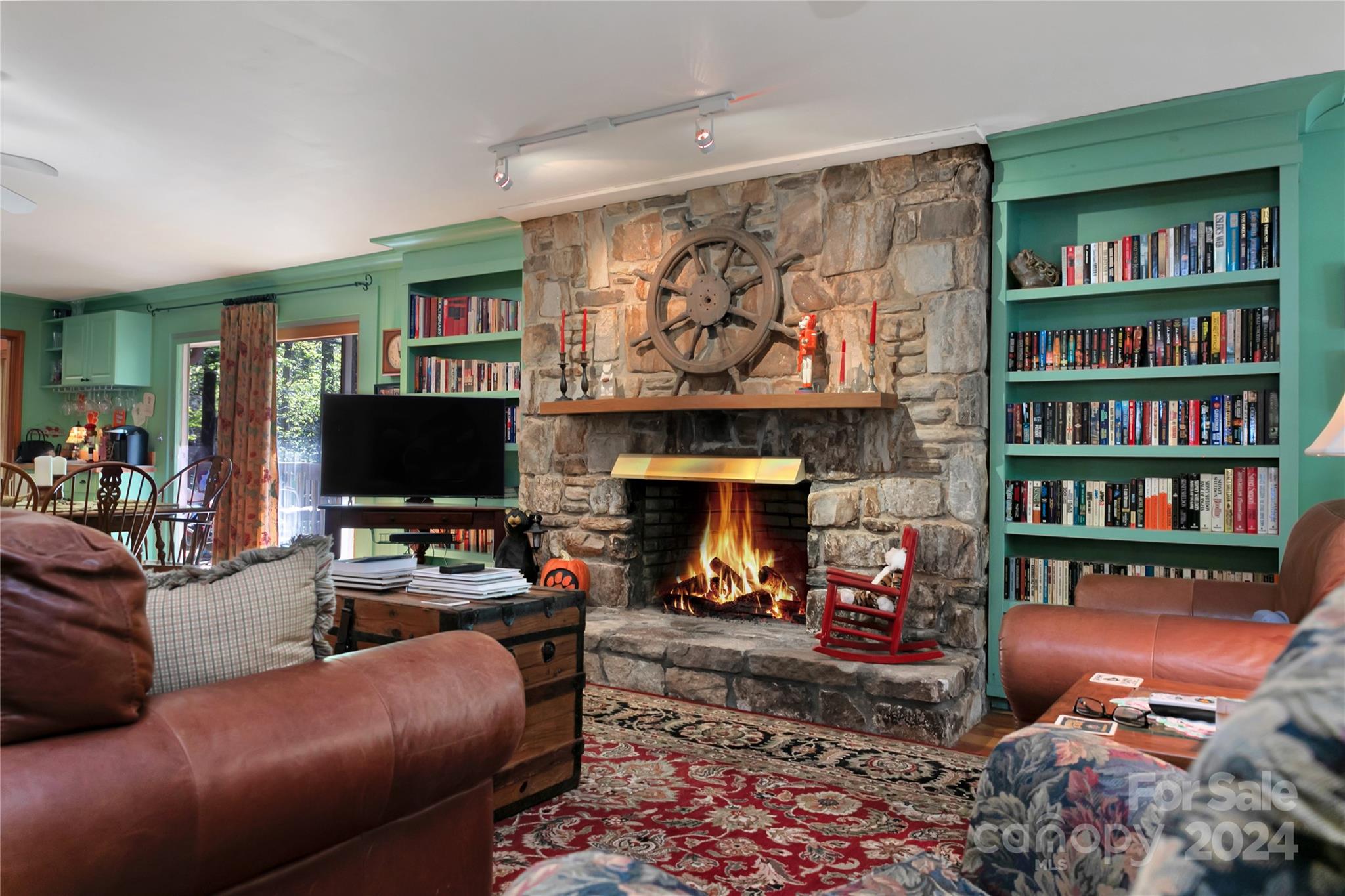 50 Summer Road Cedar Mountain, NC 28718 - Photo 11 of 41 a living room with furniture a flat screen tv and a fireplace