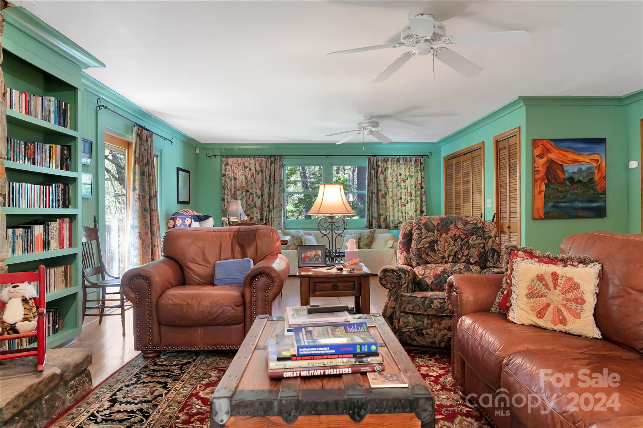50 Summer Road Cedar Mountain, NC 28718 - Photo 14 of 41 a living room with furniture a rug and a book shelf