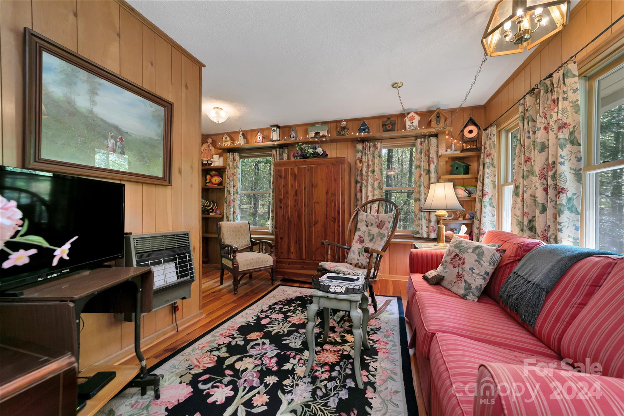 50 Summer Road Cedar Mountain, NC 28718 - Photo 32 of 41 a living room with furniture a flat screen tv and a fireplace