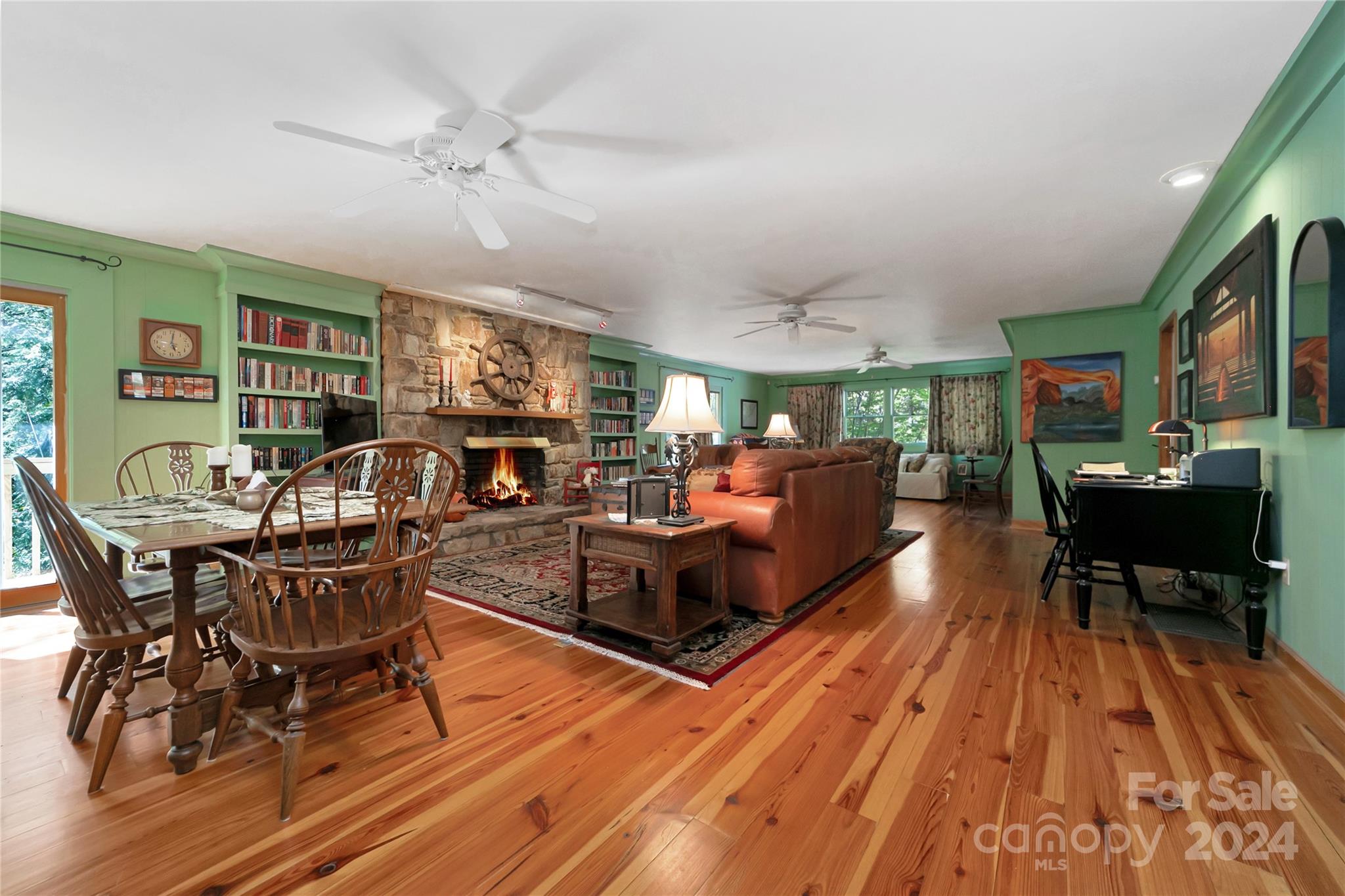 50 Summer Road Cedar Mountain, NC 28718 - Photo 10 of 41 a living room with furniture a fireplace and a flat screen tv