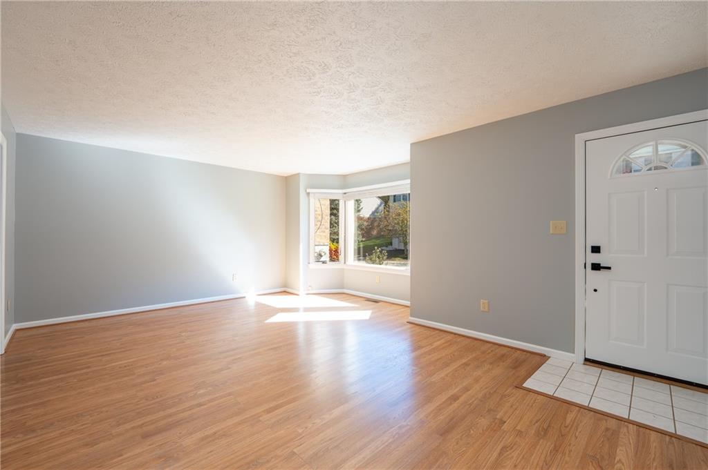 108 Unity Square Greensburg, PA 15601 - Photo 5 of 43 a view of an empty room with wooden floor and a window