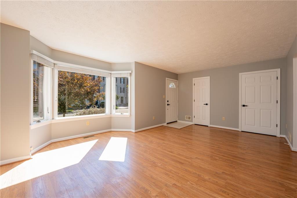 108 Unity Square Greensburg, PA 15601 - Photo 7 of 43 a view of an empty room with wooden floor and a window