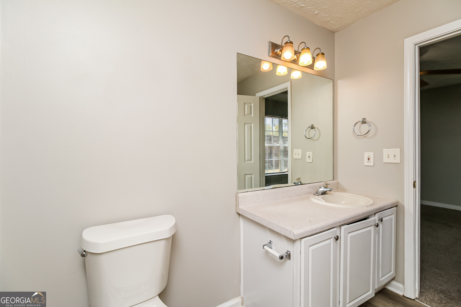 460 Mountainview Drive Covington, GA 30016 - Photo 14 of 15 a bathroom with a sink a toilet and a mirror