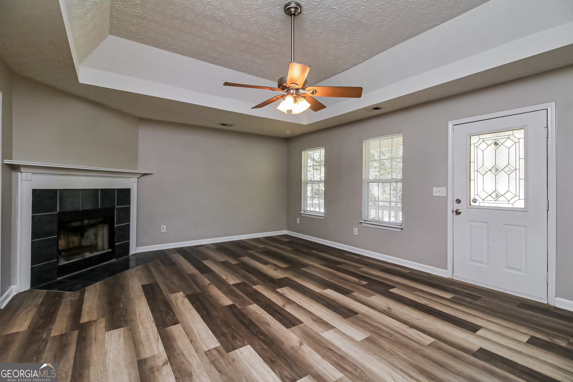 460 Mountainview Drive Covington, GA 30016 - Photo 3 of 15 a view of an empty room with window and chandelier fan