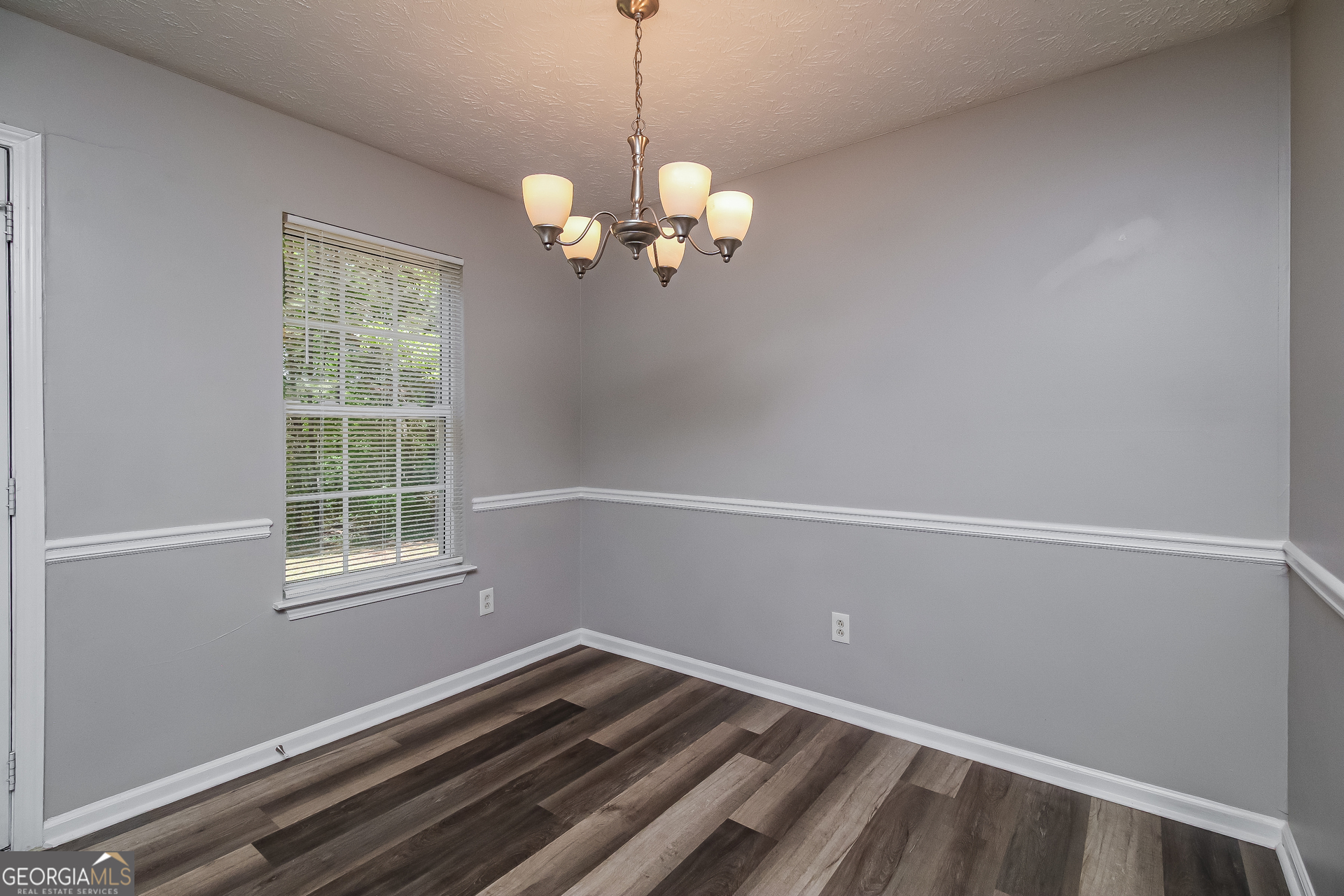 460 Mountainview Drive Covington, GA 30016 - Photo 4 of 15 a view of a room with a chandelier fan and a window