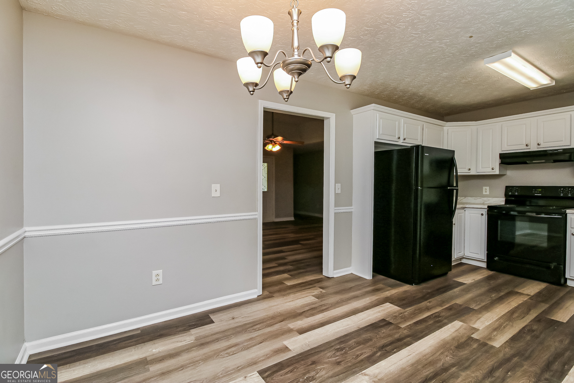 460 Mountainview Drive Covington, GA 30016 - Photo 5 of 15 a bedroom with a bed and a chandelier