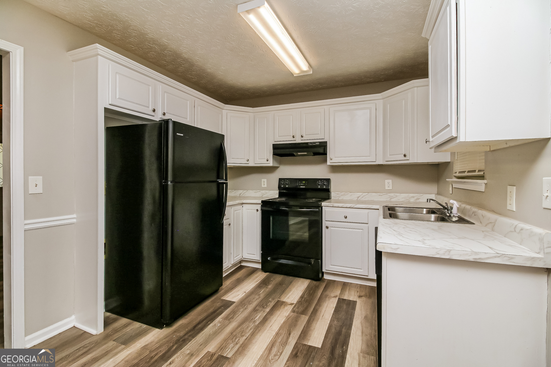 460 Mountainview Drive Covington, GA 30016 - Photo 6 of 15 a kitchen with a refrigerator stove and sink