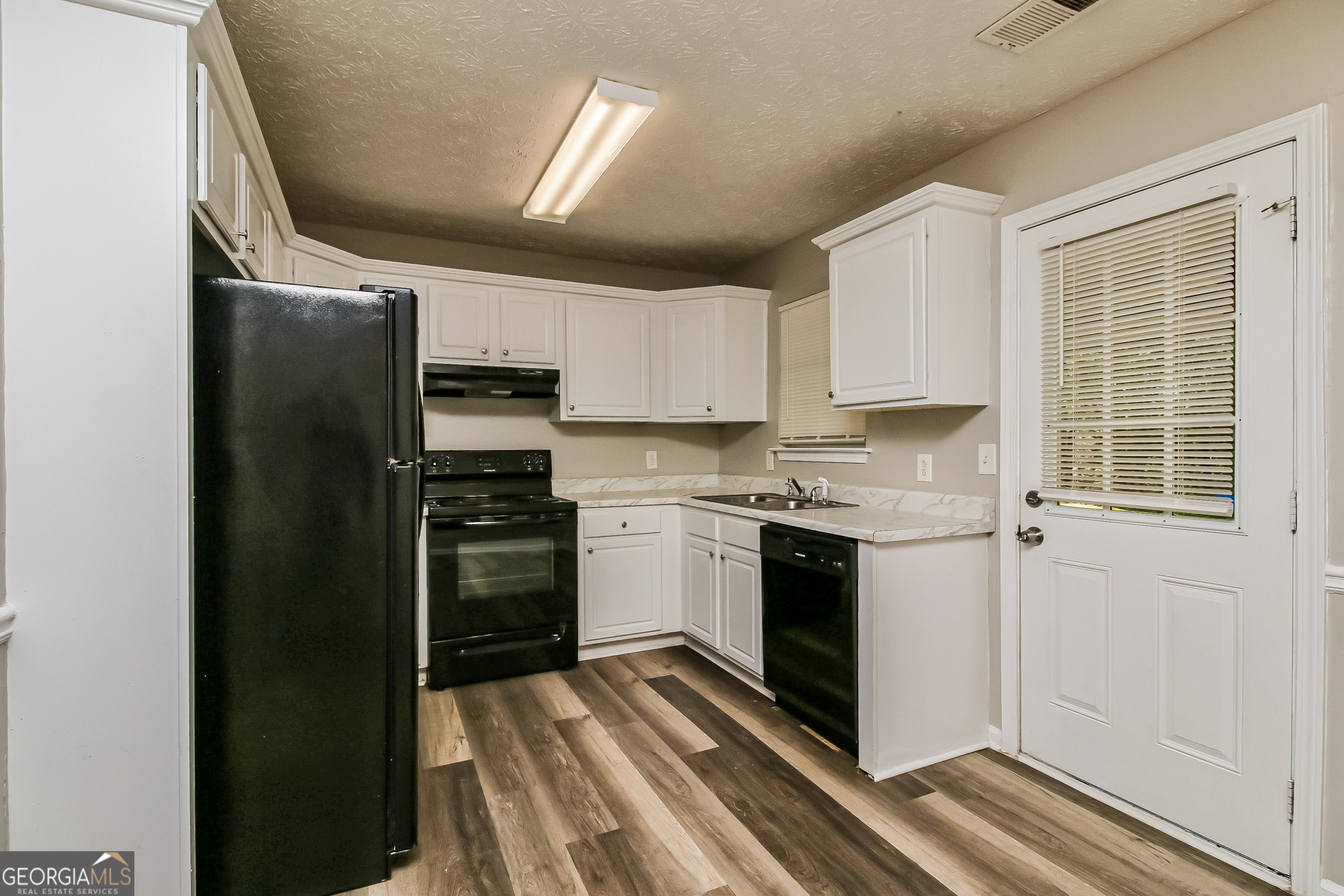 460 Mountainview Drive Covington, GA 30016 - Photo 7 of 15 a kitchen with a refrigerator stove and microwave