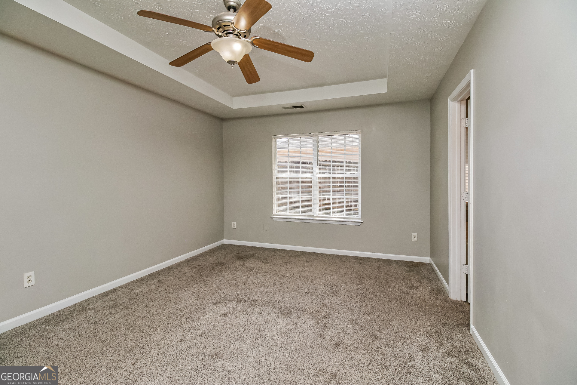 460 Mountainview Drive Covington, GA 30016 - Photo 9 of 15 an empty room with windows and fan