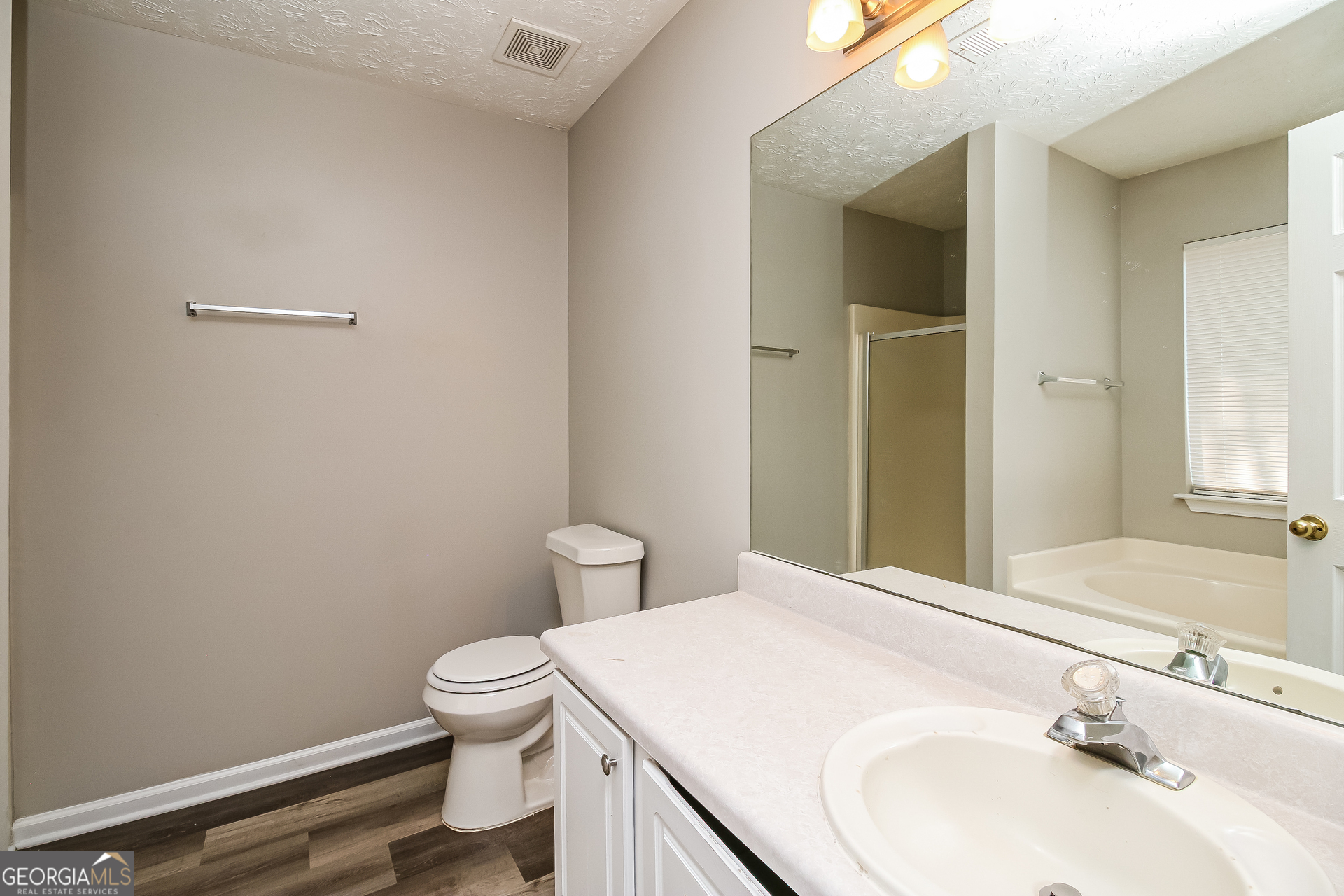 460 Mountainview Drive Covington, GA 30016 - Photo 10 of 15 a bathroom with a sink a toilet and vanity