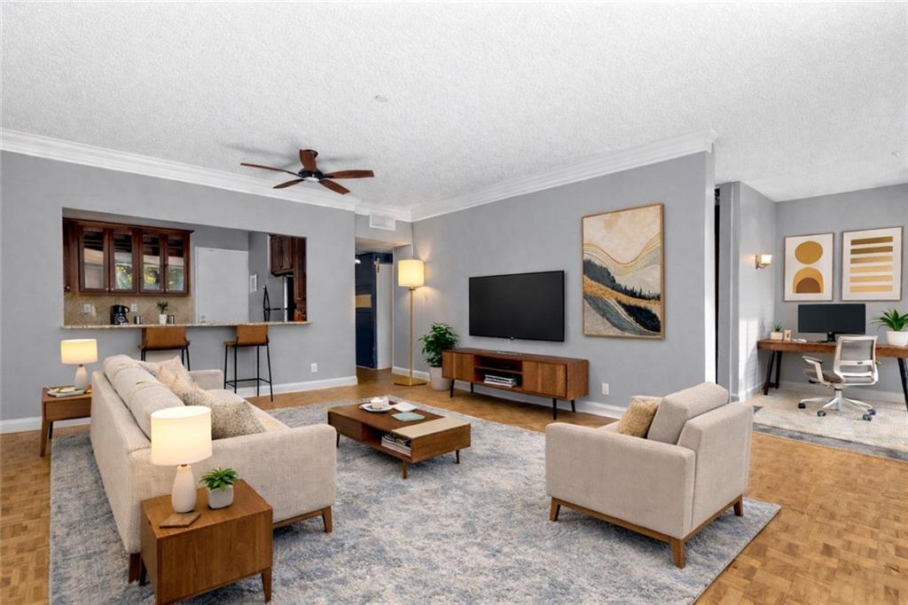 130 26th Street Northwest, Unit 307 Atlanta, GA 30309 - Photo 3 of 12 a living room with furniture and a flat screen tv