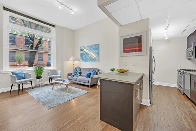 a living room with furniture and a book shelf