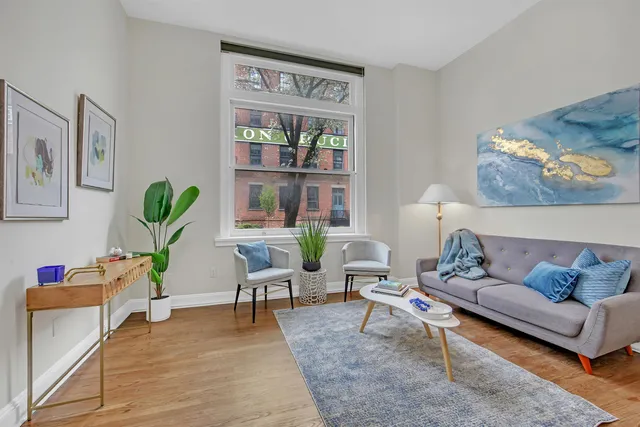 a living room with furniture and wooden floor