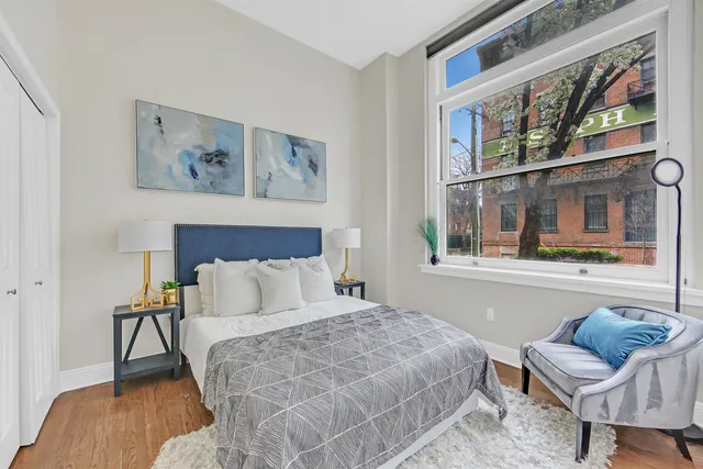 a bedroom with a bed and wooden floor