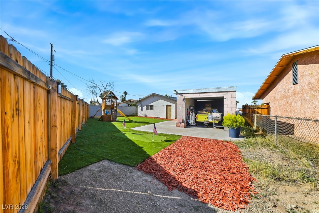 111 Copper Street Henderson, NV 89015 - Photo 14 of 47 Fenced backyard with a playground and a patio area