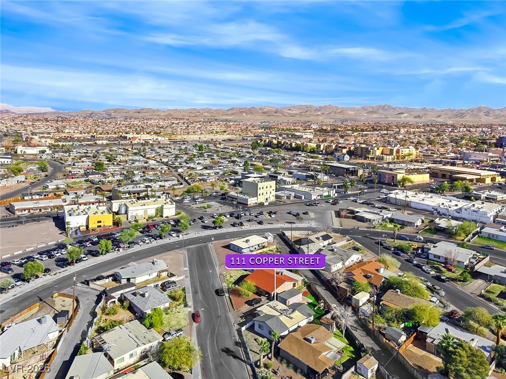111 Copper Street Henderson, NV 89015 - Photo 22 of 47 Aerial view of property and surrounding area featuring mountains and nearby suburban area