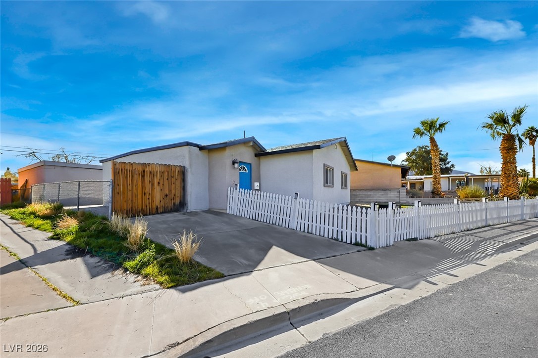 111 Copper Street Henderson, NV 89015 - Photo 24 of 47 View of front of house with a fenced front yard, stucco siding, and driveway