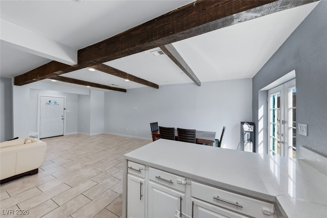 111 Copper Street Henderson, NV 89015 - Photo 47 of 47 Kitchen with open floor plan, white cabinetry, light stone countertops, and a peninsula