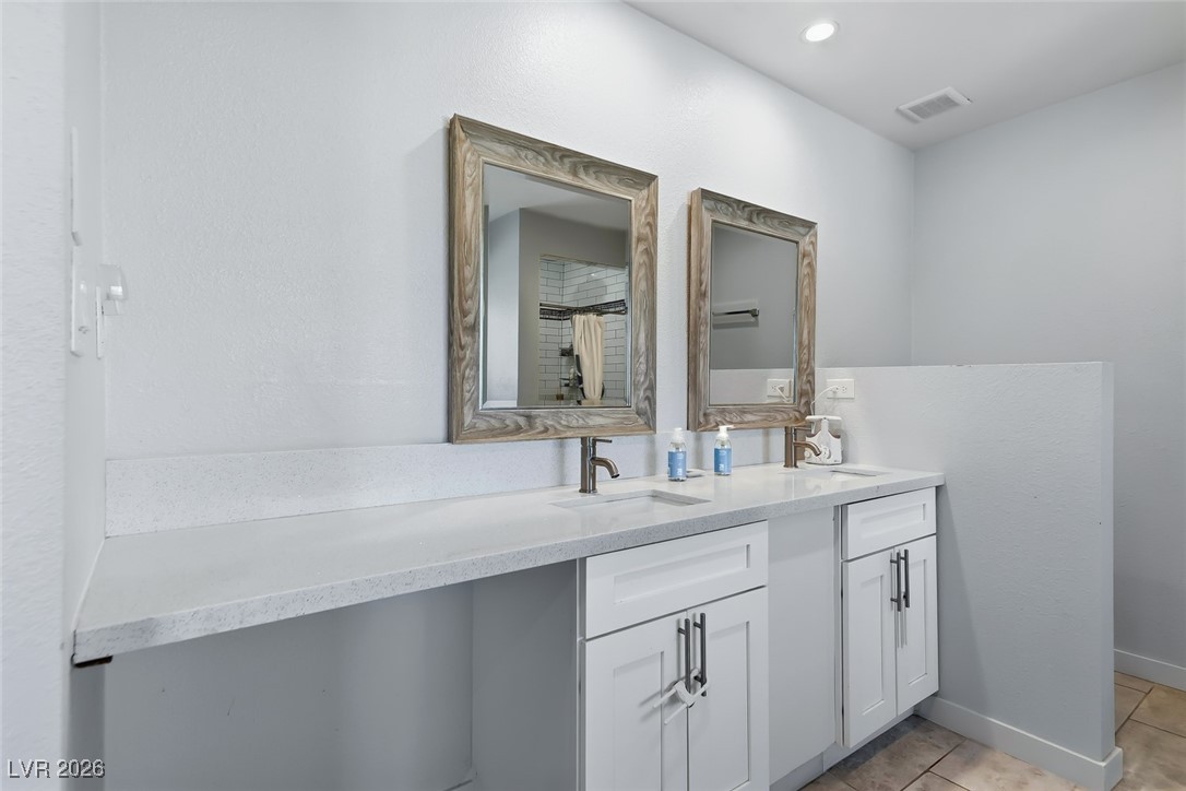 111 Copper Street Henderson, NV 89015 - Photo 45 of 47 Full bathroom with double vanity and light tile patterned floors