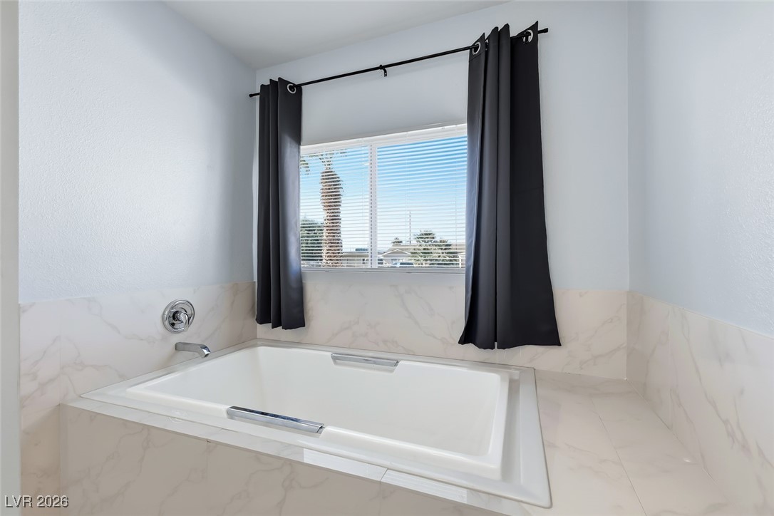 111 Copper Street Henderson, NV 89015 - Photo 6 of 47 Bathroom with a garden tub and a textured wall