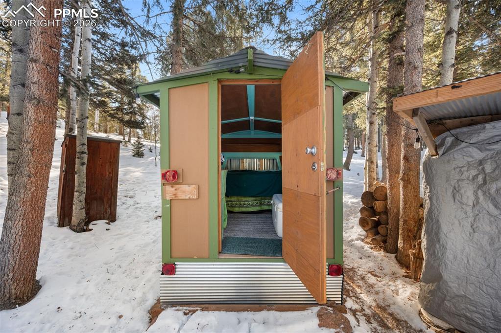 267 Kutsu Ridge Road Florissant, CO 80816 - Photo 20 of 26 a view of a house with a door and wooden walls