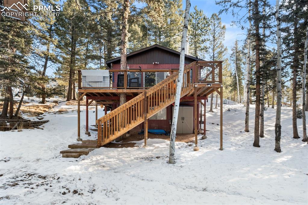 267 Kutsu Ridge Road Florissant, CO 80816 - Photo 2 of 26 a view of a house with wooden fence next to a road