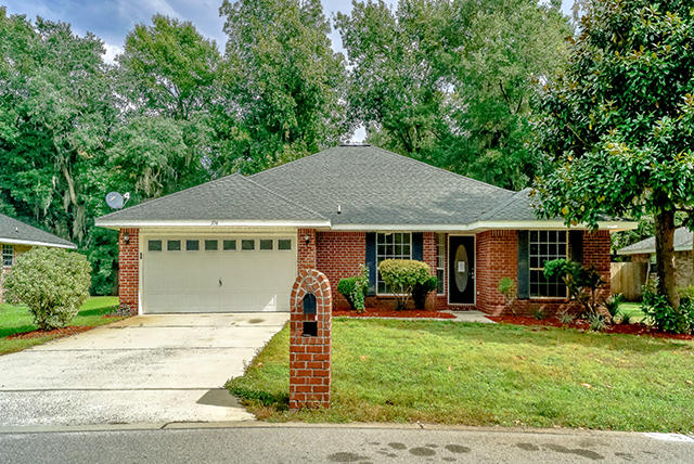 a front view of house with yard barbeque oven and outdoor seating