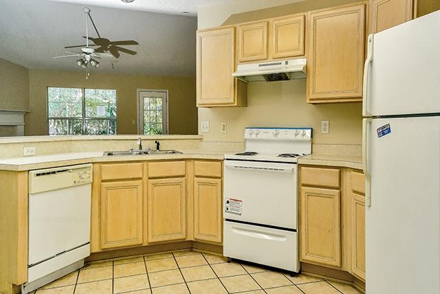 374 Beacon Way Santa Rosa Beach, FL 32459 - Photo 13 of 27 a kitchen with a refrigerator sink stove and cabinets