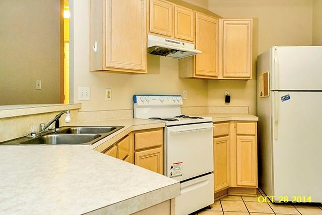 374 Beacon Way Santa Rosa Beach, FL 32459 - Photo 14 of 27 a kitchen with stainless steel appliances a sink a refrigerator and cabinets