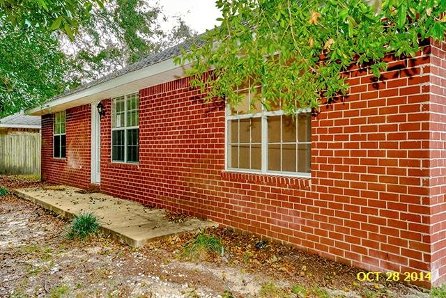 374 Beacon Way Santa Rosa Beach, FL 32459 - Photo 5 of 27 a front view of a house with a garden
