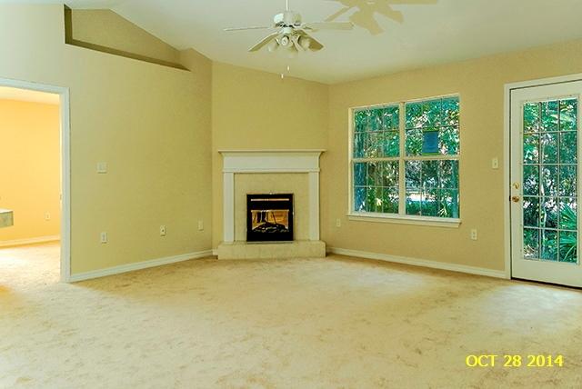 374 Beacon Way Santa Rosa Beach, FL 32459 - Photo 9 of 27 an empty room with a fireplace and windows