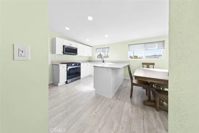 a kitchen with a sink cabinets and counter top space