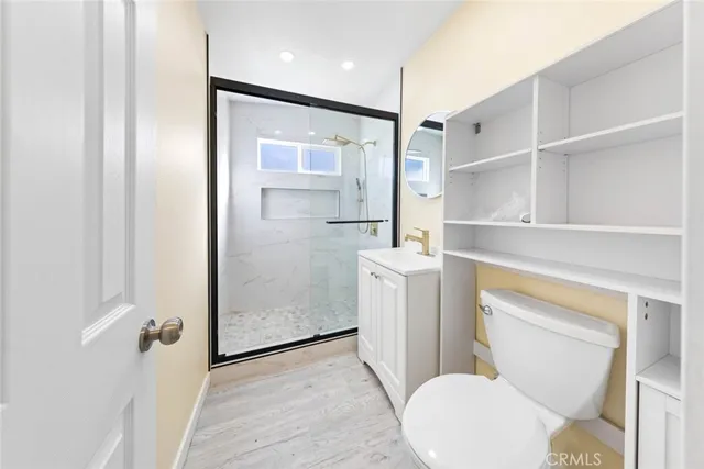 a bathroom with a toilet and a shower