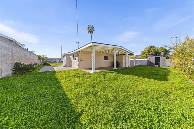 a view of a house with a big yard and potted plants