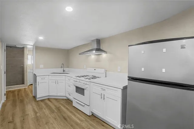 a kitchen with a stove a sink and a refrigerator