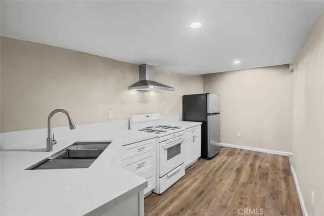 a kitchen with kitchen island stainless steel appliances a sink stove and refrigerator