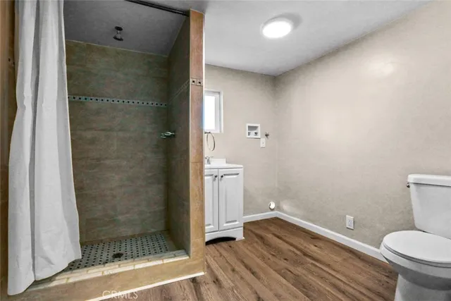 a bathroom with a toilet and a shower