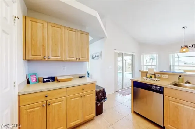 a kitchen with stainless steel appliances granite countertop a sink and cabinets with wooden floor