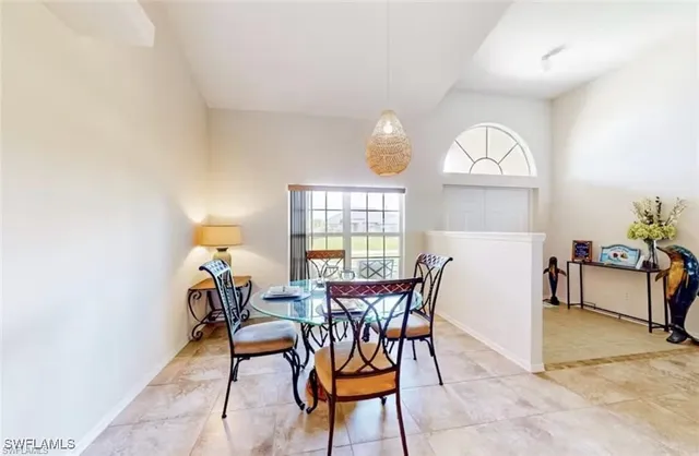 a view of a dining room with furniture and a chandelier